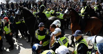 Far-right and anti-racism protesters scuffle in London