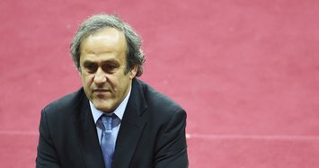 Platini says cleared by Swiss authorities, plans return