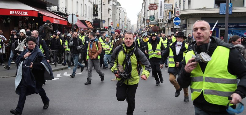 POLICE FIRE TEAR GAS AT YELLOW VEST PROTESTERS CALLING FOR RESIGNATION OF MACRON