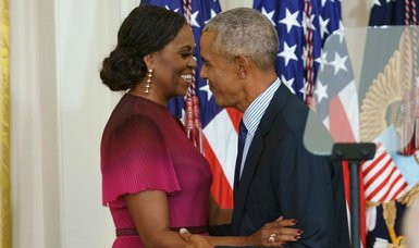 Obamas return to White House for official portraits unveiling