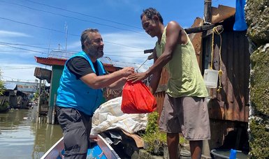 Turkish agency distributes Ramadan aid to people living in floating river village in Philippines