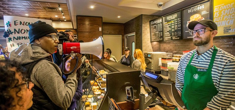 Scores of protesters at Starbucks chant company is 'anti-black'