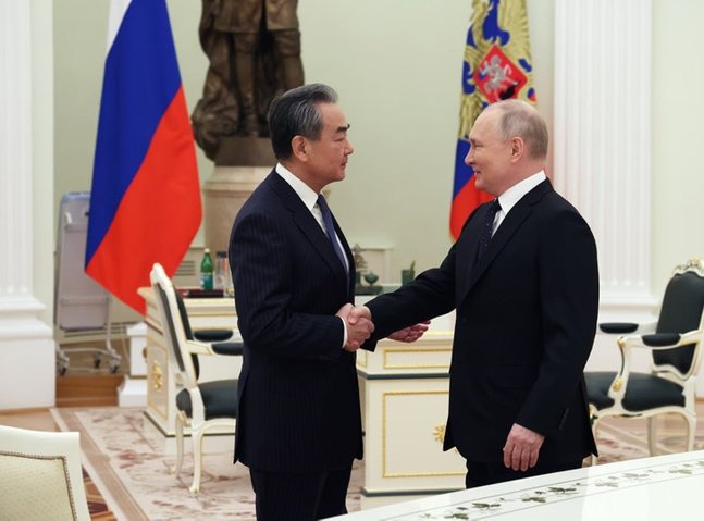 China's Wang tells Putin: We will play constructive role on Ukraine - TASS