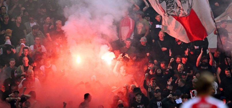 AJAX-FEYENOORD ABANDONED AFTER FLARES LOBBED ON PITCH
