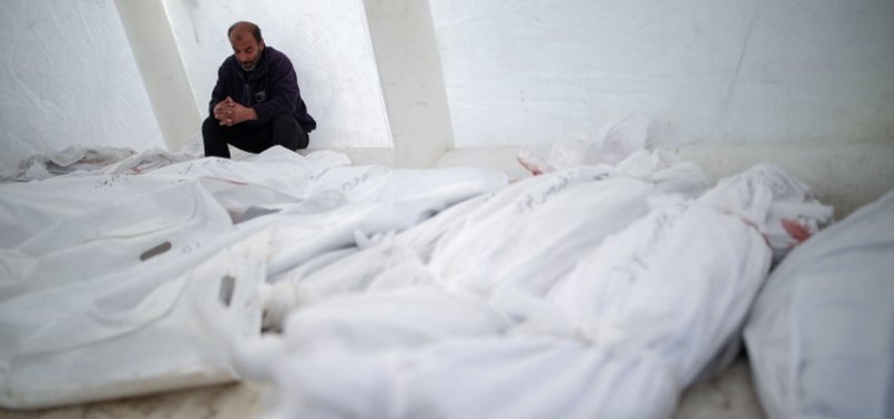 PALESTINIANS BURY GAZAN CIVILIANS KILLED BY BLOODY-MINDED ISRAELI FORCES IN MASS GRAVE - WITNESSES