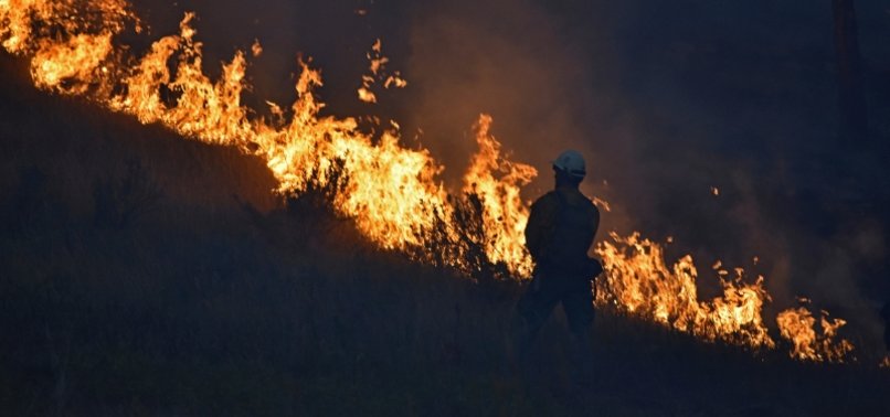WILDFIRE BEARS DOWN ON MONTANA TOWNS AS AMERICAN WEST BURNS