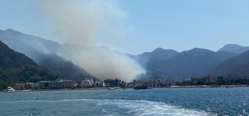 TURKISH FIREFIGHTERS TRY TO EXTINGUISH WILDFIRE IN MARMARIS FROM LAND AND AIR