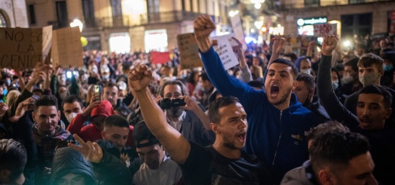 PROTESTERS IN SPAIN CLASH WITH POLICE OVER CURFEW