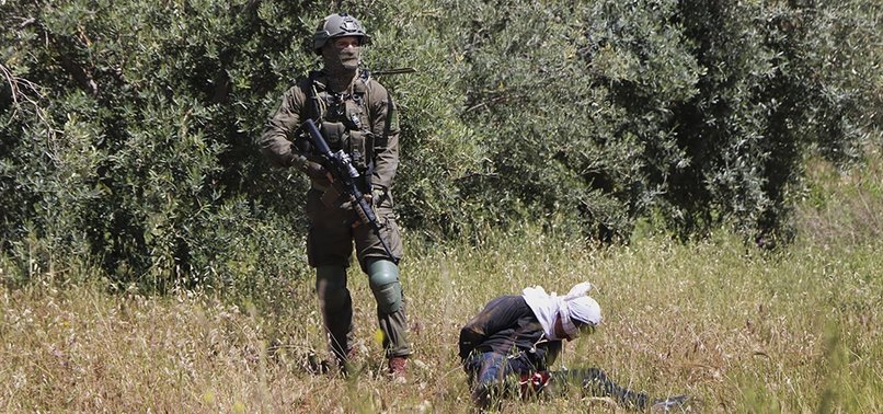 ISRAELI SOLDIERS SHOOT HANDCUFFED AND BLINDFOLDED PALESTINIAN TEEN
