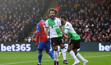 Salah nets 200th goal as Liverpool go top with 2-1 win over 10-man Palace