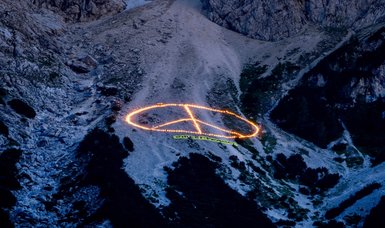 Greenpeace projects climate message onto mountain near G7 venue