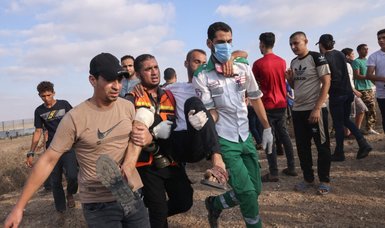 Israeli troops fire at Palestinian protesters in Gaza Strip, leaving dozens injured