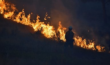 Wildfire bears down on Montana towns as American West burns