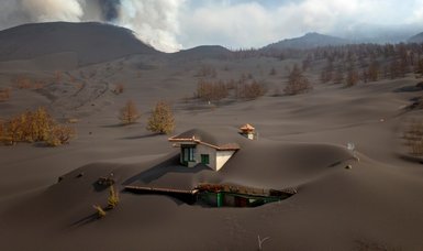 Ash from erupting volcano forces Spanish islanders indoors