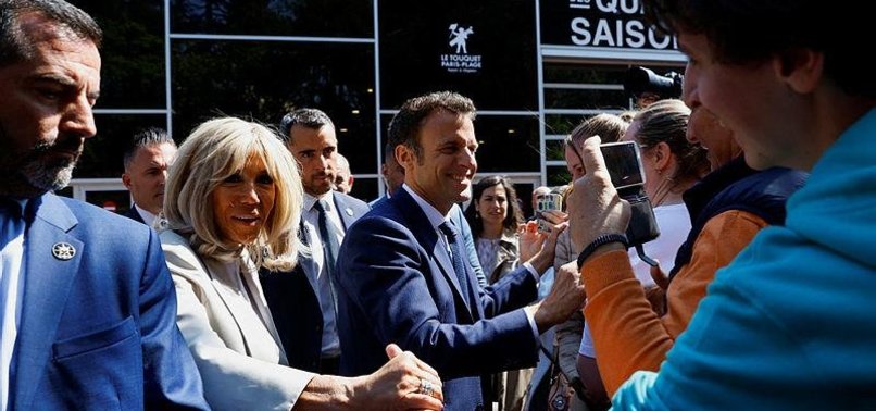 MACRON CASTS VOTE, MEETS SUPPORTERS OUTSIDE POLLING STATION