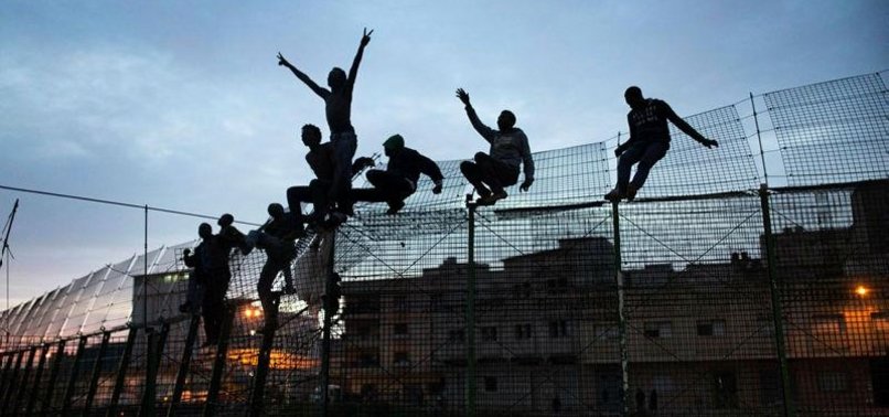 MIGRANTS CHARGE BORDER FENCE; 6 INJURED
