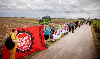 Thousands of activists rally to call for a quick halt to coal mining in western Germany