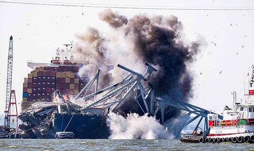 Demolition charges used to free cargo ship from wreckage of bridge