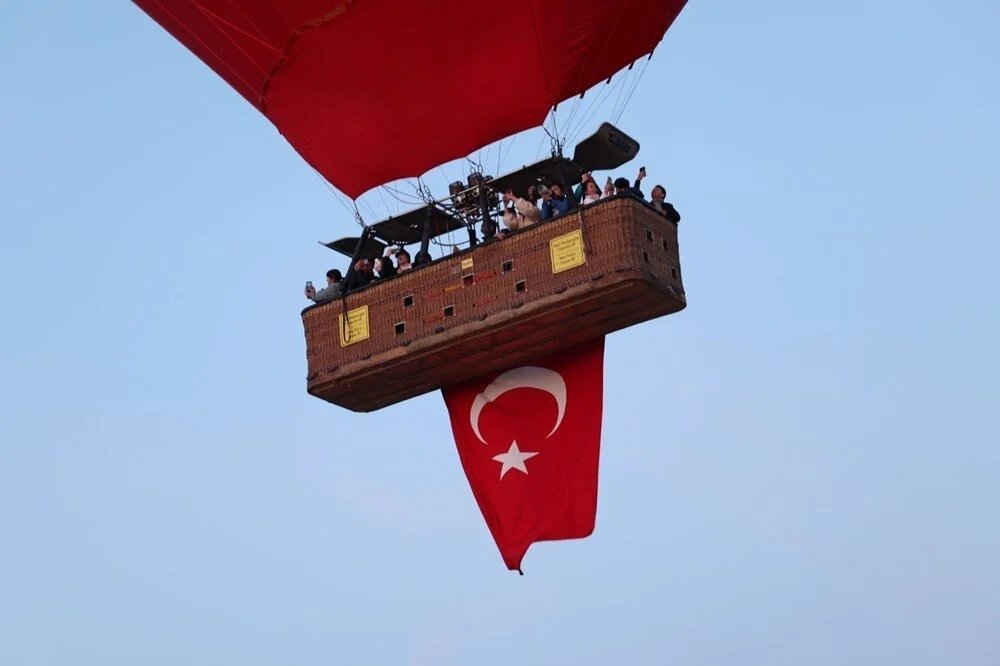 Cappadocia hot air balloons fly with Turkish flags for Victory Day