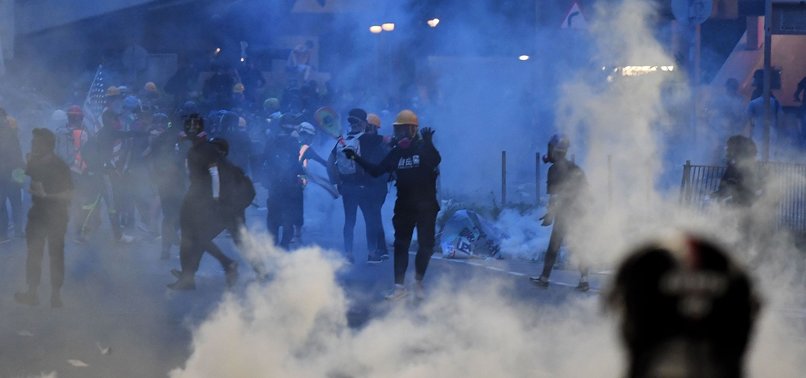 HONG KONG POLICE FIRE TEAR GAS AT ANTI-GOVERNMENT PROTESTERS AS MARCHERS DEFY BAN