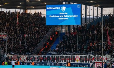 Bundesliga match delayed by 40 minutes after fans refuse to remove flags
