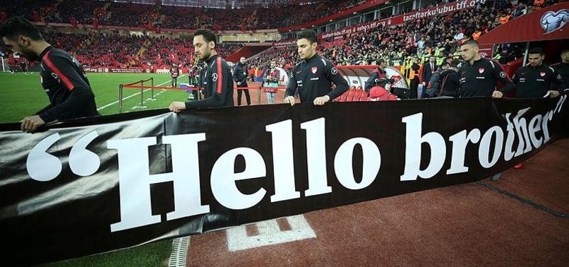 TURKISH FOOTBALLERS HOLD HELLO BROTHER BANNERS