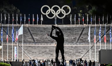 Athens hands Olympic flame to Paris 2024 organizers