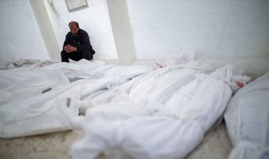 Palestinians bury Gazan civilians killed by bloody-minded Israeli forces in mass grave - witnesses