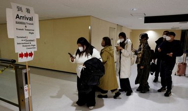 Japan to end mandatory virus tests for travelers from China