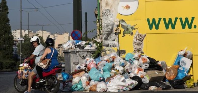 GARBAGE PILES UP IN GREEK CAPITAL AMID JOB FREEZE AND HEAT WAVE
